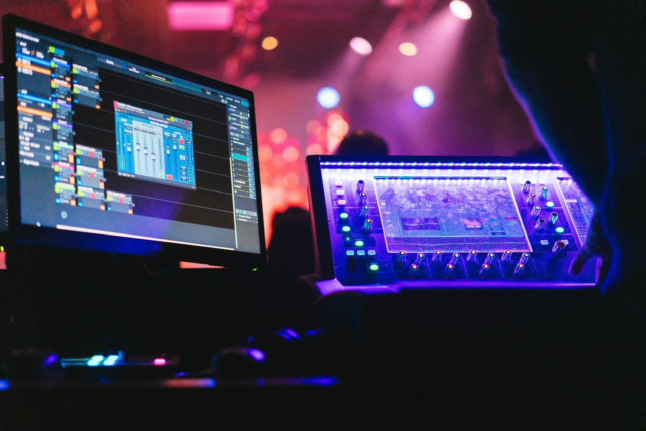 Audio engineer operating a digital mixing console at a live event